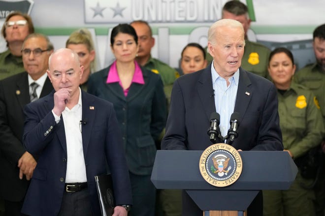 Secretary of Homeland Security Alejandro Mayorkas, left, listens as President Joe Biden speaks at the Border Patrol Station in Brownsville, February 29.